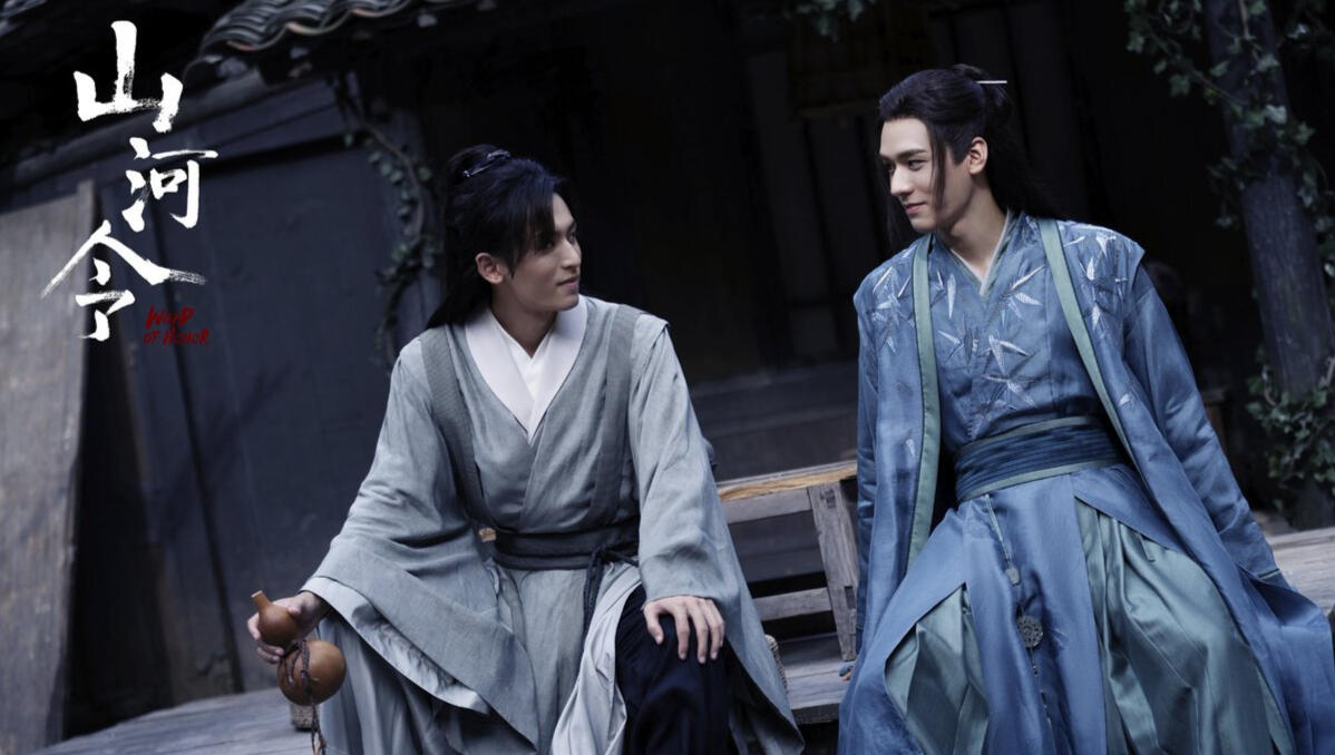 shl's zhou zishu and wen kexing on a bench and smiling at each other