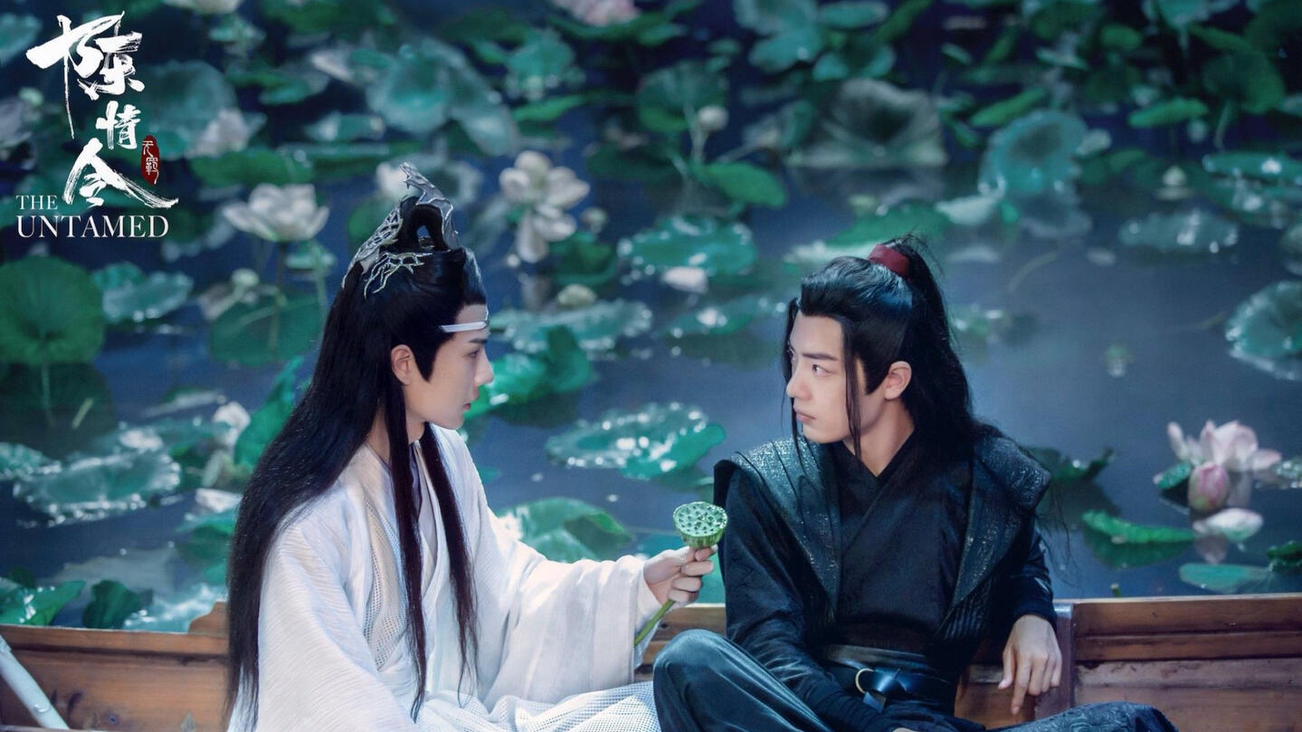 cql's lan wangji and wei wuxian on a boat in a lotus pond, lan wangji offering wei wuxian a lotus head